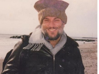 Michael on the beach in Cape May, NJ in 1995, wearing a hat from Afghanistan.